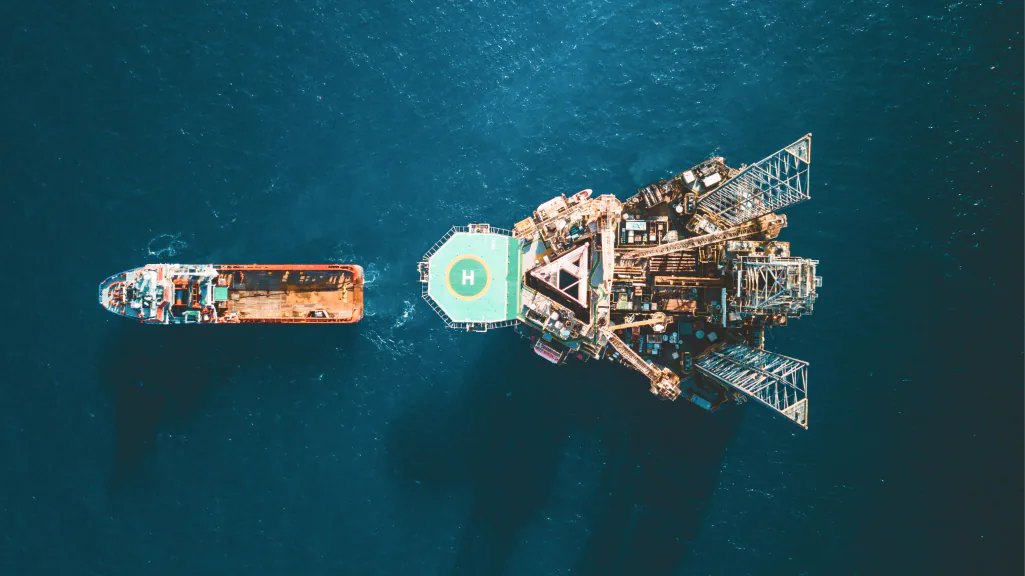 A banner image of the Vortex logo next to an oil tanker leaving an offshore rig